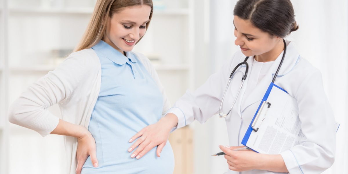 doctor-keeping-hand-tummy-her-pregnant-patient